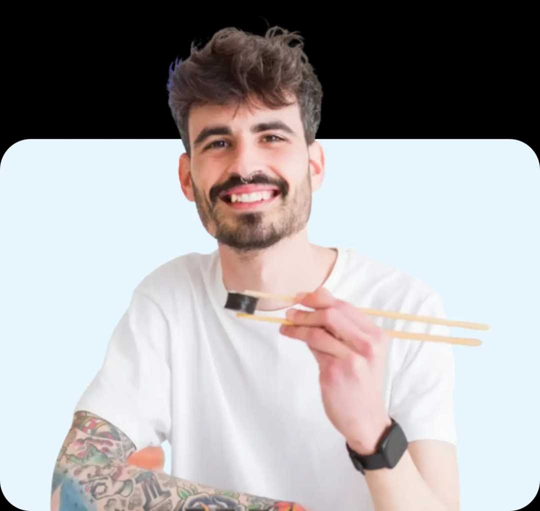 Image of a smiling man eating sushi